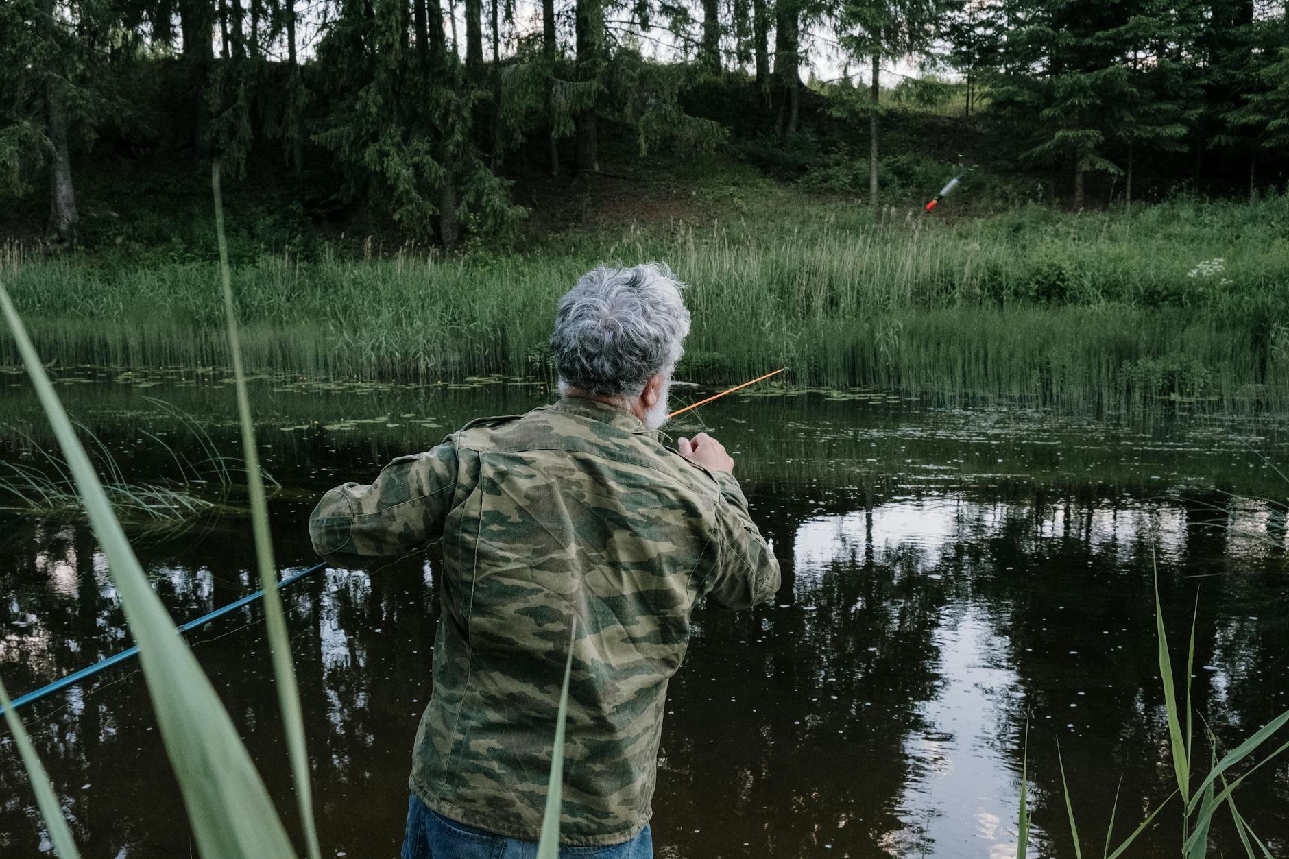 Cinematic lakeside view with float fishing setup at dawn